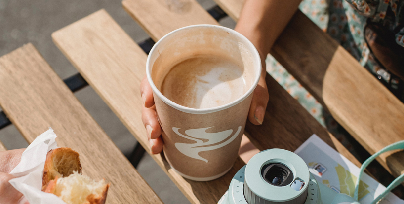 Hands Holding Coffee in Disposable Cups